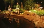 Endicott House horticulturist Steve Wiswell (left) and Grounds Department head Andy Turcotte stand in the garden exhibit they created at the New England Spring Flower Show to exemplify the original rock garden from early 19th-century Endicott House. The exhibit won six awards and a gold medal.