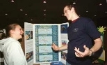 Freshman Jon Varsanik (right), a swim team member, chatted with Francesca Izzo of Graham and Parks School, another swimmer, about her study on the science of swimming.