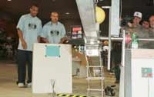 Anthony Thomas helps contestant Will Lark with his robot during the competition.