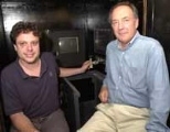 Graduate student Camillo Padoa-Schioppa (left) and Professor Emilio Bizzi studied monkeys' movements using the computer joystick that Padoa-Schioppa has his hand on.
