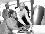 Alexander d'Arbeloff, chair of the MIT Corporation, works at a computer with Davina Griffith, a participant in SPES (Supplemental Program of Educational Skills), a nonprofit after-school program in Dorchester.