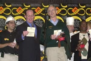 Cambridge Mayor Anthony Galluccio (second from left) and President Charles M. Vest sing a duet at the Infinite Buffet. Others with them include Soulaymane Kachani (far left), one of the event's student organizers, executive chef Peter Dumke (in chef's hat) and Dean for Graduate Students Isaac Colbert (far right).