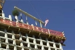 Once the last precast section was raised into place atop Simmons Hall on Vassar Street, the building had its "topping off" with the traditional tree and flag last week.