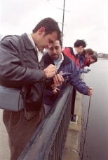 Trying out the new ENVIT system on the Massachusetts Avenue bridge are (left to right) graduate students Richard Camilli, Enrique Vivoni (lowering a line into the river to retrieve a water sample) and Ching-Huei Tsou; senior Amy Watson; and graduate student Russ Spieler.