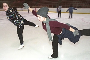 Alexandra Dunne-Bryant, Wellesley  '02, rear, gives some tips to Yana Averbukh, MIT '05, as they practice spirals  during an IAP figure skating class.
