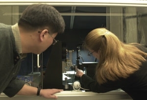 The new NanoMechanical Technology Laboratory is  equipped with state-of-the-art machines for the study of atomic and molecular  scale materials. Graduate students Yoonjoon Choi (left) and Krystyn Van Vliet  of materials science and engineering work with a nanoindenter that can probe and  measure the properties of materials' surfaces.