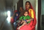 A woman and her sick child wait to be seen at the International Buddhist Society free clinic in Lumbini, the birthplace of Buddha.