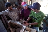 Master potter Hari Gobindh (left) of the village of Thimi near Kathmandu works with Susan Murcott and MIT student Jason Low to make a water filter of sawdust, rice husk, ash, and red clay.