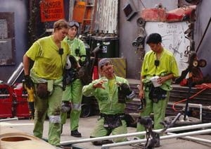 The Quantum Mechanics--from left, Danielle Smith, team captain Leila        Hasan, expert Nord Embroden (knelling) and Kim Hamad-Schifferli--plan        their sand yacht in their junkyard workshop.
