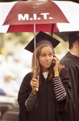 Maria Ferrer has her Commencement equipment at the ready: an umbrella in one hand and a cell phone in the other.