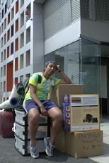 Smitha Raghunatha, a sophomore in mechanical engineering, sits atop a mountain of a friend's belongings prior to moving into Simmons.