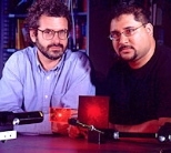 Media Lab professor Neil Gershenfeld, left, and MIT graduate Ravi  Pappu with an epoxy token made of tiny glass spheres that may improve digital  information security on the Internet and elsewhere.