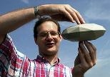 Researcher Steven Slivan displays a model he made to explain the orientation of asteroids.