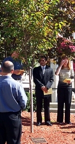 Father Paul Reynolds (behind tree), Prashant Arce-Doshi (S.B. 1995) and Jacqueline Henke (S.B. 1997) were among those who gathered at the Alpha Phi house to plant a tree in memory of Lizette Arce-Doshi (S.B. 1995).