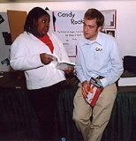 Thrinisha Sanders (left), an eighth-grader at the Hernandez School, and her MIT mentor Colin Galbraith, a senior in materials science and engineering, look at the manual for the new computer that the students received for their efforts in the Science Projects at MIT program.