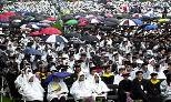 A very colorful, if very wet, crowd of families and other well-wishers sat through a soggy Commencement.