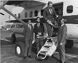 M. Curt Young (right), president of Atlantic City Airlines greets MIT Professor Eugene Larrabee. The gentlemen at left were not identified.