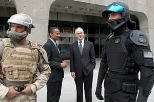 During the              opening of the ISN at MIT, Army Equipment Spc. Dan Harshman, left,              and Sgt. Raul Lopez, right, model prototypes of future combat uniforms,              while Claude Bolton, Jr., Assistant Secretary of the Army for Aquisition,              Logistics and Technology, second from left, and MIT President Charles              M. Vest look on.