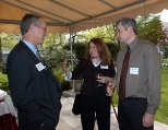 Associate Professor Roger Petersen of political science and his wife, Daniella Stojanovic, chat with President Charles M. Vest at the Gray House reception for 16 professors granted tenure by the Executive Committee of the MIT Corporation.
