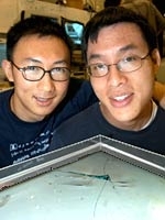 Graduate students David Hu, left, and Brian Chan with their creation, Robostrider.