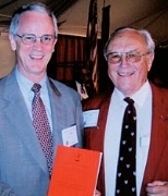 Alf Bjercke (MIT 1943), right, presents his thesis to MIT President Charles M. Vest, which he plans to defend this winter to three professors at the University of Oslo.