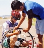 Taku, standing, helps Kyle attend to his second flat tire, just outside Billings, Mont.