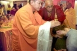 Venerable Thich Thien-Hue, a Vietnamese monk and abbot of the Buddhist Center in Braintree, Mass., blesses Richard J. Barbalace (S.B. 1997), assisted by Venerable Tenzin Priyadarshi Shukla, the Buddhist chaplain at MIT. The blessing is being conducted with a relic from Shakyamuni Buddha, founder of Buddhism.