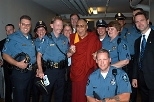 The Dalai Lama poses with members of the MIT Police Department. They are (from left): Sgt. Craig Martin, Sgt. Cheryl Vossmer, Sgt. Richard Sullivan, Det. Sgt. Mary Beth Riley, Deputy Chief John Driscoll, Patrol Officer Bob Wilcox, Officer Billy Boulter (kneeling), Sgt. Janet Colwell-Popp, Lt. Al Pierce (rear) and Det. Jay Perault.