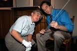 Deborah Douglas, science and technology curator at the MIT Museum, examines one of the thermometers (held by Professor of Mechanical Engineering John H. Lienhard) stored for more than a century in the chest behind them.