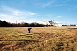 A man acts as a human bulls-eye to guide a cropduster over an optical occultation disdrometer, which can measure aerosol size distributions in the .25 to 25 millimeter range.