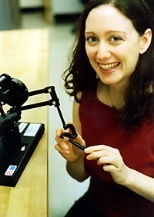 Sommer Gentry with the robotic arm she programmed to "dance" with her.