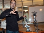 Aaron Edsinger, a graduate student in electrical engineering and computer science, demonstrates some of the robot research going on in the Stata Center.