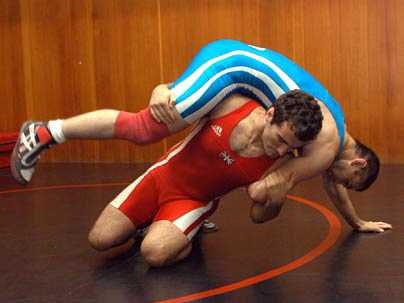 Mathematics graduate student Nate Ackerman, in red, trains with colleague Vadzim Fliaha at MIT. Ackerman holds dual citizenship in the USA and Great Britain, and will wrestle for Great Britain in the summer 2004 Olympics in Athens. <a onclick="MM_openBrWindow('olymp-wrestler-enlarged.html','','width=509, height=583')">
<span onmouseover="this.className='cursorChange';">Open image gallery</span>
</...