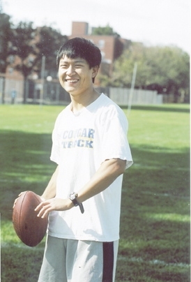Tian He, who writes Patriots' news in Mandarin, strikes a Tom Brady-like pose during an intramural football game on Briggs Field.