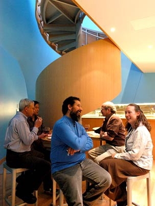 Recent revelers at the new R and D pub at the MIT Stata Center were, from left, Professor John Guttag; architect Thomas Kim (behind Guttag); Simon J. Hernandez, research technician for W3C; Professor Alan Willsky, and Karen Gardner, personnel coordinator for CSAIL. Guttag and Willsky, both professors in EECS, created the pub's wine list.