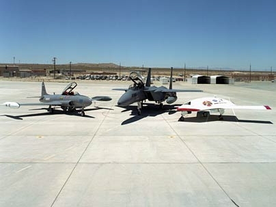 A test of the MIT manned-to-unmanned guidance system at Edwards Air Force Base used, from left, a Lockheed T-33 trainer fighter jet and a Boeing F-15 fighter jet. Eventually an unmanned aerial vehicle, right, will be used in place of the trainer jet.