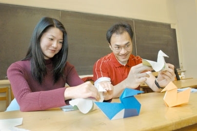 Jie Zhang and her fiance Allen Miu, a graduate student in computer science, work on their second duck form in the workshop.