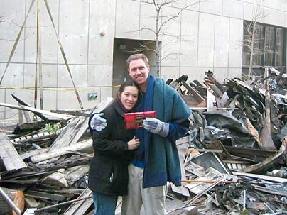 MIT teaching assistant Wes Austin and his girlfriend, Tanya Stankunas, hold a chocolate bar that miraculously survived the fire in their apartment.