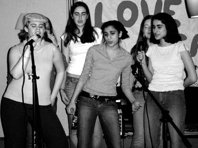 Left to right: Sophomores Katelyn Giovannuci, Adrienne Hunacek, Jayodita Sanghvi, Emily Pfeiffer and Roshni Cooper belt out a song like rock stars during last Friday's Coffeehouse karaoke night sponsored by SaveTFP.