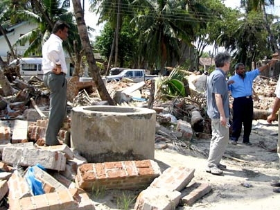 A coastal well surrounded by debris.