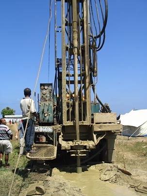 Personnel from the Water Resources Board in Sri Lanka drill for water in a displaced persons' camp in Amparai.