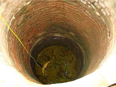 Probing a well to measure its salinity.