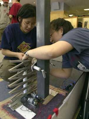 Danielle Chou, left, helps with a machine in its early design phase during the 2002 contest.