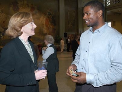 President Susan Hockfield speaks with administrative assistant Andre Dixon of the Office of Academic Services at a May 3 inaugural reception.
