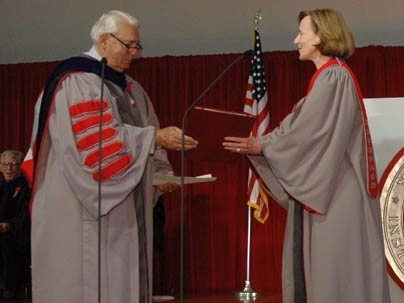 President Susan Hockfield accepts the leather-bound copy of MIT's charter from Dana G. Mead, chairman of the Corporation -- the act by which she formally becomes the Institute's 16th president.