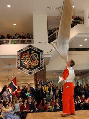 A block party performer balances a large table on his chin at the May 7 festivities celebrating Susan Hockfield's inauguration.