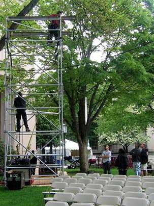 MIT Facilities workers assemble scaffolding to hold the giant video screen that will allow Commencement proceedings to be visible to all attendees on Killian Court.