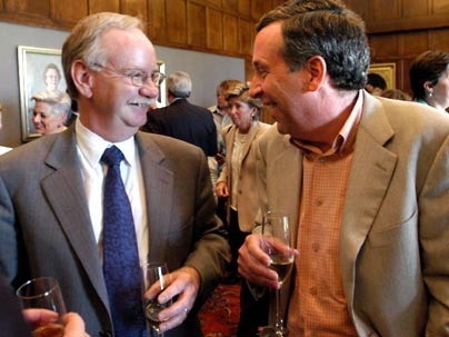 Provost Robert A. Brown, left, enjoys a surprise party held Monday, June 6, to congratulate him on his appointment to the presidency of Boston University. He is in the Emma Rogers Room chatting with Lawrence S.  Bacow, the former chancellor of MIT who now serves as president of Tufts University.