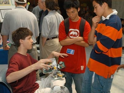 A student from Minnesota's Roosevelt High School InvenTeam explains the team's portable smoke detector for the hearing impaired.