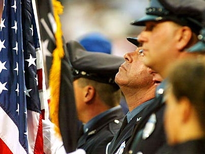 MIT police Lt. Daniel Costa is caught in a solemn moment Tuesday, Aug. 30, before the Red Sox game at Fenway Park. MIT's police honor guard presented the colors at the game.